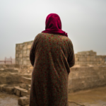 Sahala looks at the part of her family’s house that was destroyed when their village was occupied by ISIS. Returning to Tulaband, Iraq, after explosives were cleared and schools were restored, the family now faces challenges to rebuilding their home and livelihood. © Emily Garthwaite/Article 36